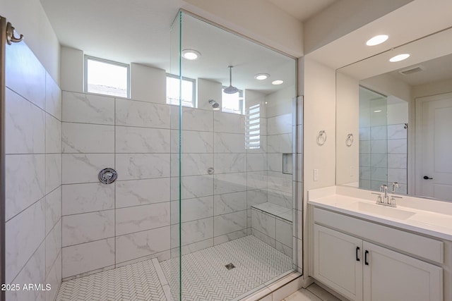 bathroom featuring vanity and a shower with shower door