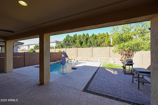 view of patio / terrace with a fenced in pool and a grill