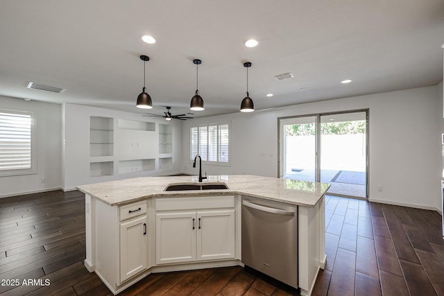 kitchen featuring white cabinetry, sink, stainless steel dishwasher, light stone counters, and a center island with sink