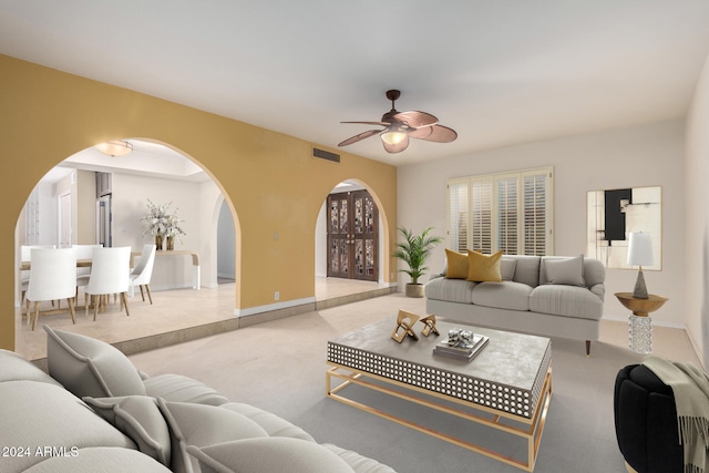 living room featuring ceiling fan and light carpet