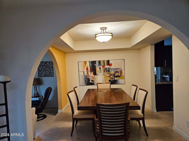 dining area with a tray ceiling