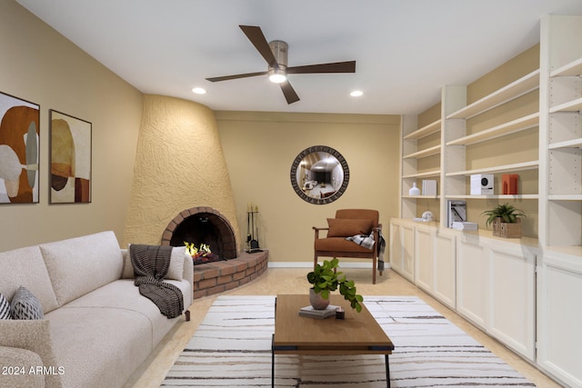 living room with ceiling fan, light colored carpet, and a fireplace