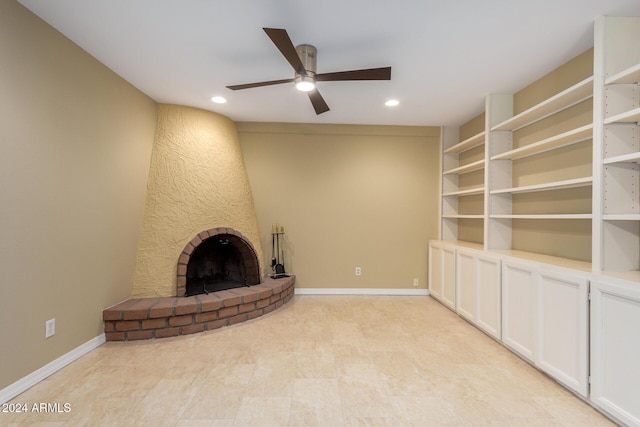 unfurnished living room with ceiling fan and a fireplace