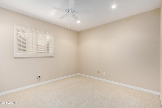 empty room featuring carpet floors and ceiling fan