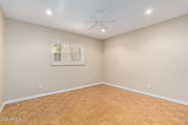 spare room featuring ceiling fan and light parquet flooring