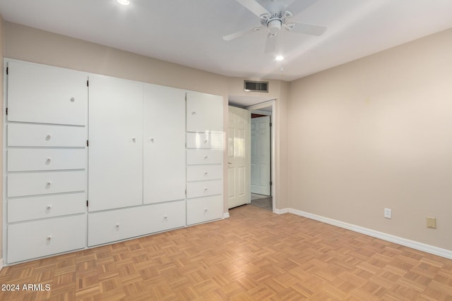 unfurnished bedroom with light parquet flooring and ceiling fan