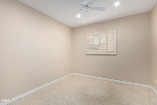 carpeted spare room with ceiling fan