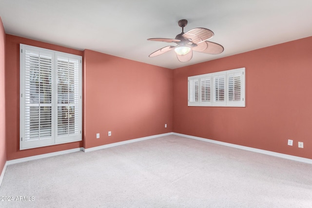 carpeted spare room with ceiling fan