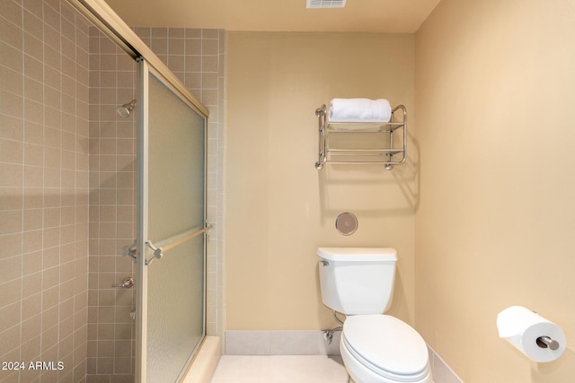 bathroom with toilet and walk in shower