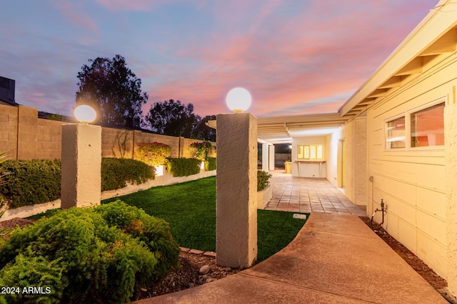 yard at dusk featuring a patio area