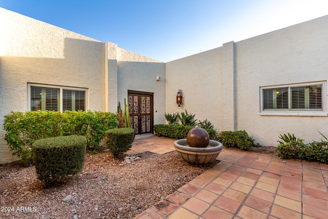 doorway to property with a patio area