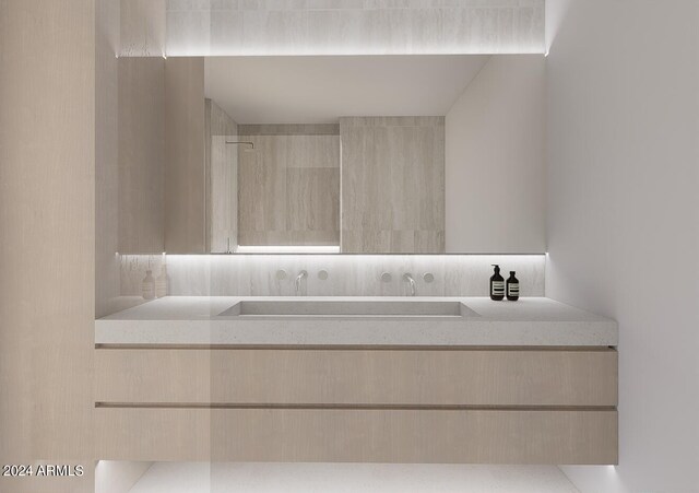 bathroom featuring a tile shower and vanity