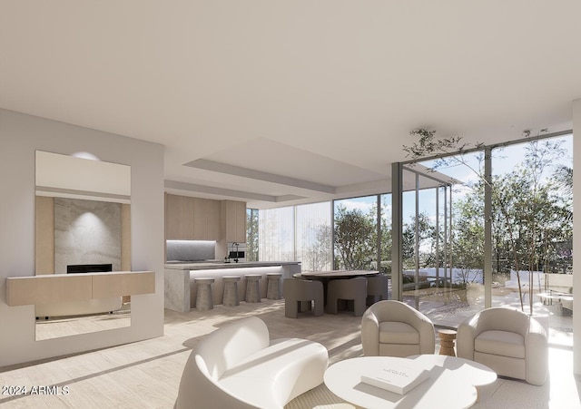 living room featuring a wall of windows and a fireplace