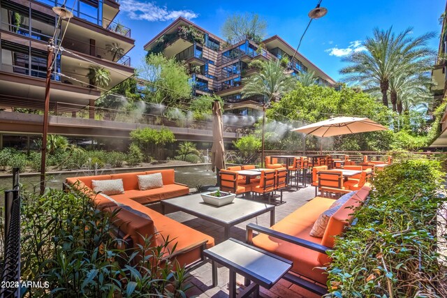 view of patio featuring a balcony and an outdoor living space