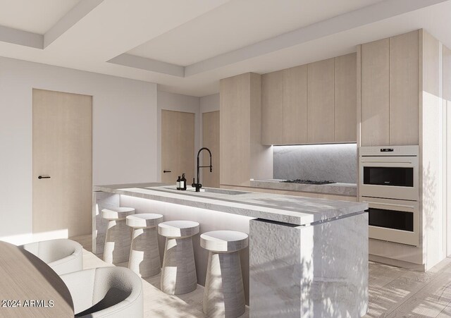 kitchen featuring white double oven, light brown cabinets, gas stovetop, a tray ceiling, and sink