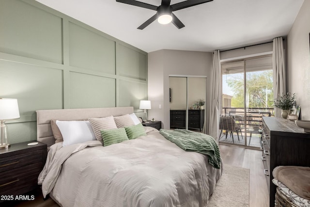 1411 E Orangewood Ave Unit 233, Phoenix, AZ 85020 - bedroom with access to outside, wood finished floors, a ceiling fan, and a decorative wall