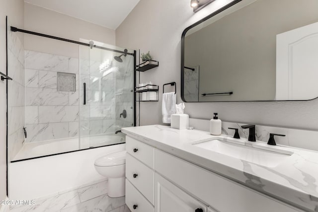 1411 E Orangewood Ave Unit 233, Phoenix, AZ 85020 - full bathroom featuring toilet, vanity, marble finish flooring, and combined bath / shower with glass door