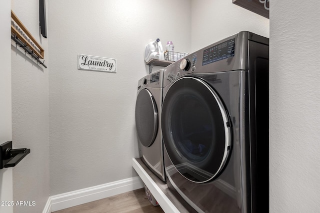 1411 E Orangewood Ave Unit 233, Phoenix, AZ 85020 - laundry area with washing machine and dryer, wood finished floors, and baseboards