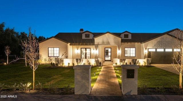 view of front of home with a front yard and a garage