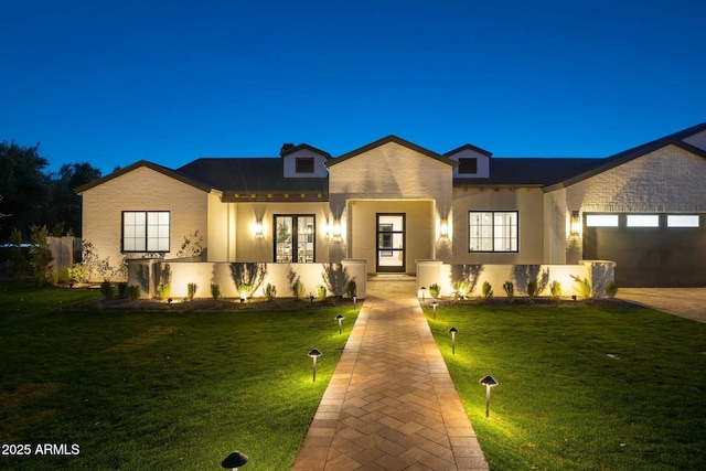 view of front of house with a garage and a front lawn