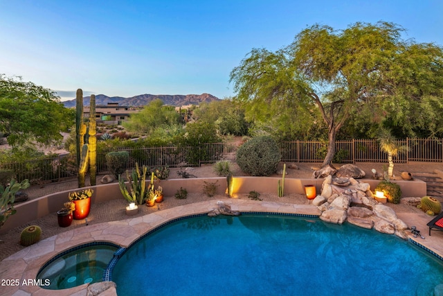 view of pool with a mountain view and an in ground hot tub