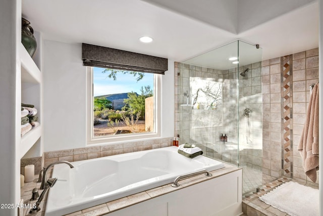 bathroom featuring shower with separate bathtub