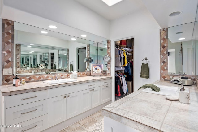 bathroom with decorative backsplash, tile patterned flooring, and vanity