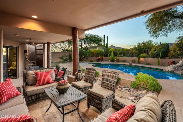 view of swimming pool with a patio area, outdoor lounge area, and ceiling fan