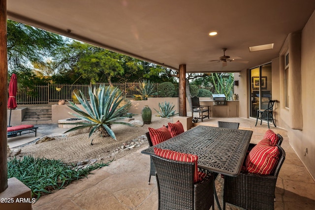 view of patio featuring area for grilling, a grill, and ceiling fan