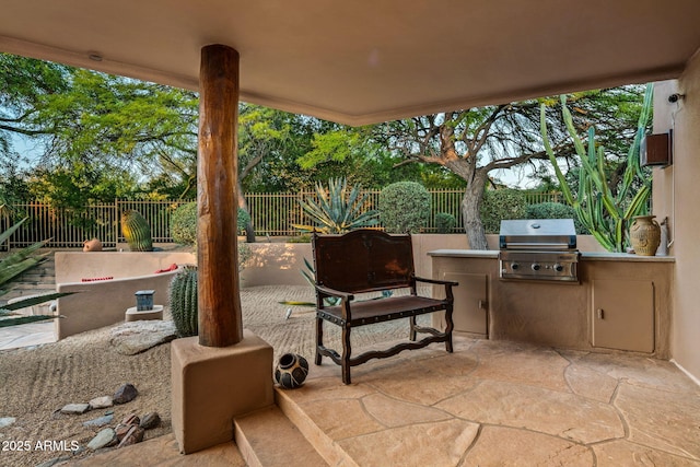 view of patio / terrace featuring an outdoor kitchen and a grill