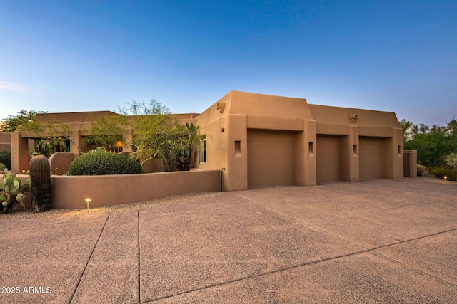 southwest-style home with a garage