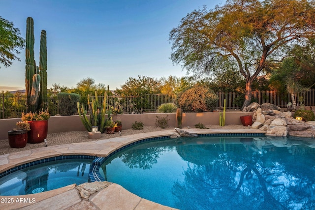 view of pool featuring an in ground hot tub