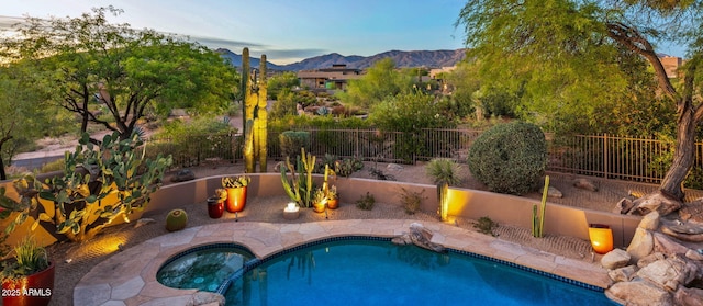 view of pool with a mountain view and an in ground hot tub