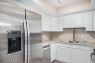 kitchen featuring sink, white cabinets, and stainless steel appliances