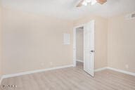 unfurnished room with ceiling fan and light wood-type flooring