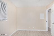 unfurnished room with light wood-type flooring