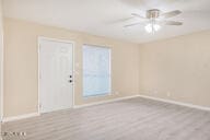 empty room featuring ceiling fan and light hardwood / wood-style flooring