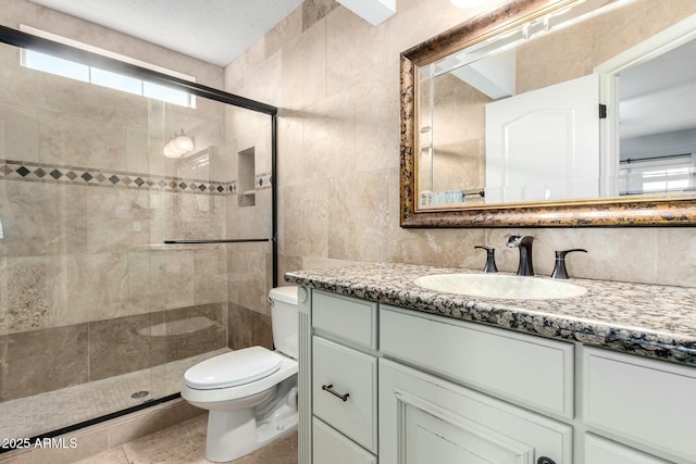 5253 E Waltann Ln, Scottsdale, AZ 85254 - full bathroom with a shower stall, vanity, tile walls, and toilet
