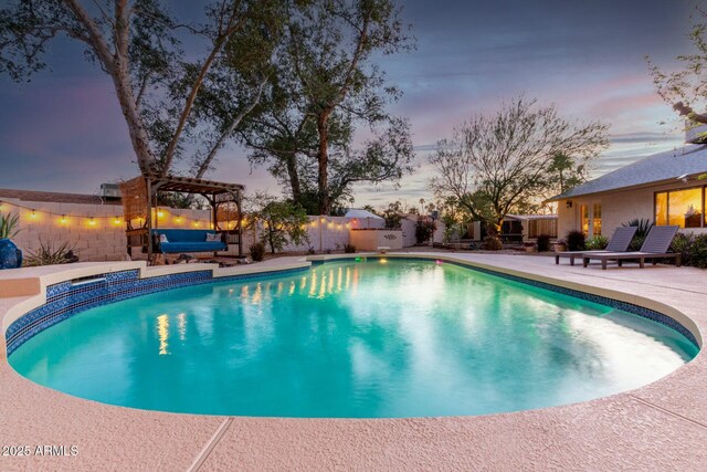 5253 E Waltann Ln, Scottsdale, AZ 85254 - pool at dusk with a patio, a pergola, a fenced in pool, and fence