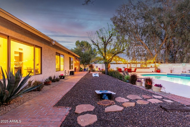 5253 E Waltann Ln, Scottsdale, AZ 85254 - yard at dusk with a fenced backyard, a fenced in pool, and a patio area