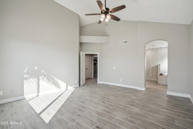 empty room featuring ceiling fan, high vaulted ceiling, and light hardwood / wood-style floors