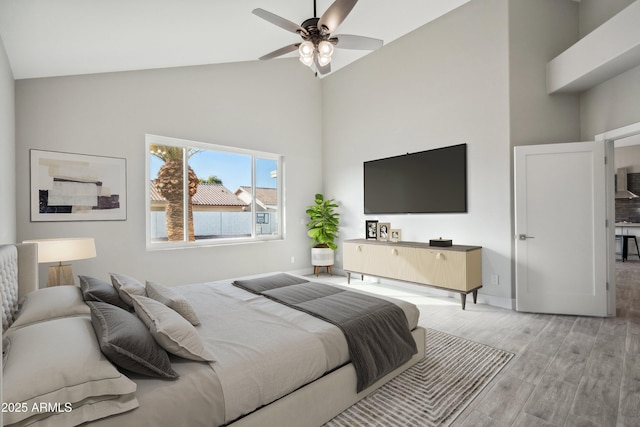 bedroom featuring high vaulted ceiling and light wood-type flooring