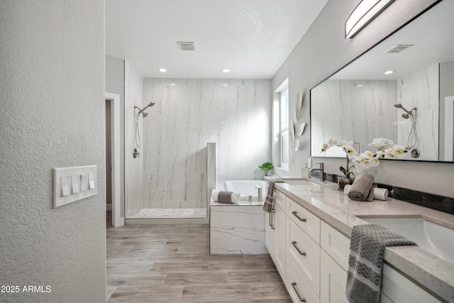 bathroom featuring vanity, separate shower and tub, and hardwood / wood-style floors