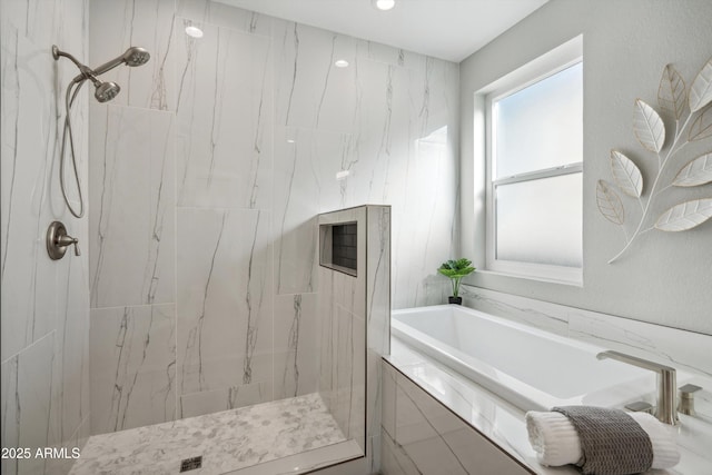 bathroom with shower with separate bathtub