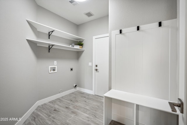 laundry room featuring hookup for a washing machine, gas dryer hookup, hookup for an electric dryer, and light hardwood / wood-style floors