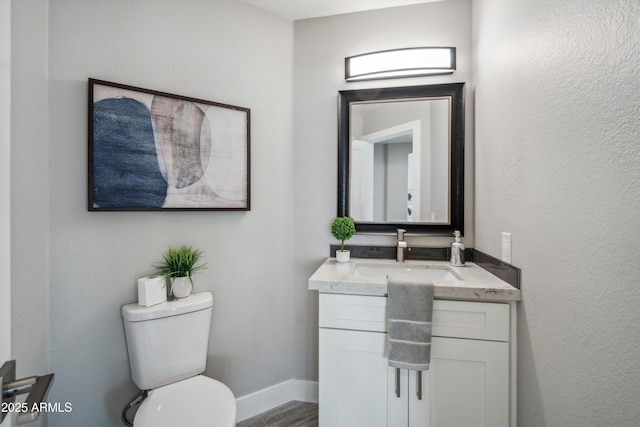 bathroom with vanity, hardwood / wood-style flooring, and toilet