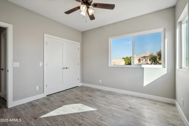 unfurnished bedroom with ceiling fan and light hardwood / wood-style flooring