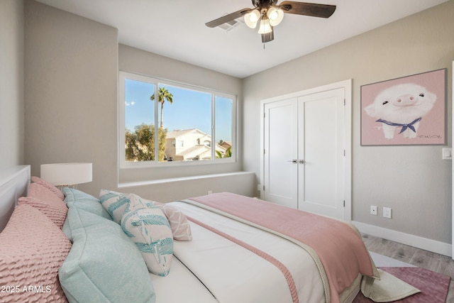 bedroom featuring wood-type flooring, a closet, and ceiling fan