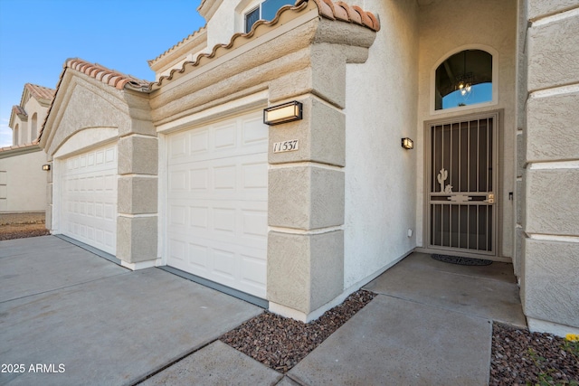 view of exterior entry featuring a garage