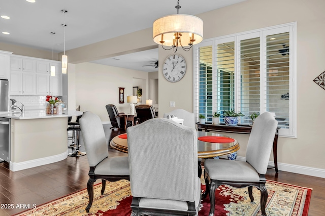 dining room featuring recessed lighting, baseboards, dark wood-type flooring, and ceiling fan with notable chandelier